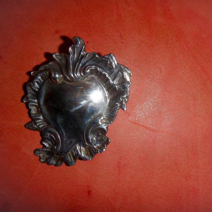 My Piledriver Heart album cover — a silver ex-voto heart on a red ground